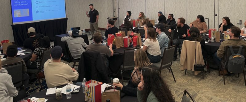 Socium team retreat 2023 session, people divided into groups watching presentation.