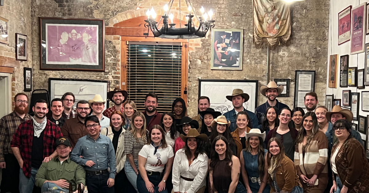 Socium team retreat dinner at Gueros, group photo of everyone dressed in cowboy attire.